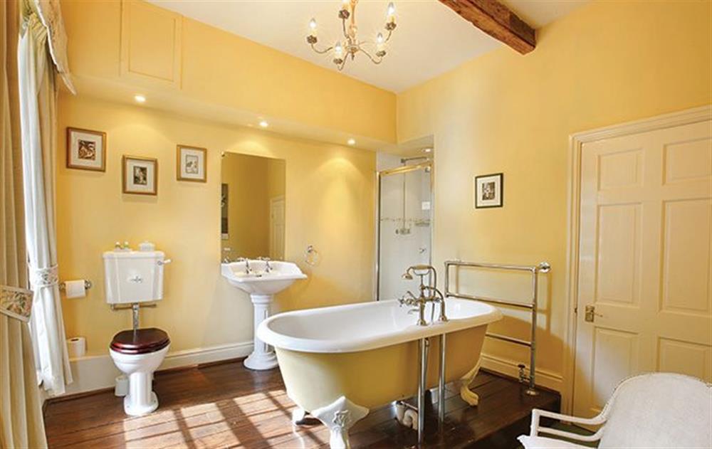 Master en-suite bathroom with roll-top bath and dressing area. at Melmerby Hall, Melmerby