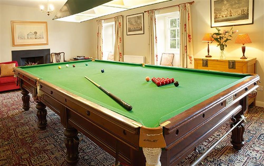 The billiards room has a full-size table and an open fire at Melmerby Hall, Melmerby