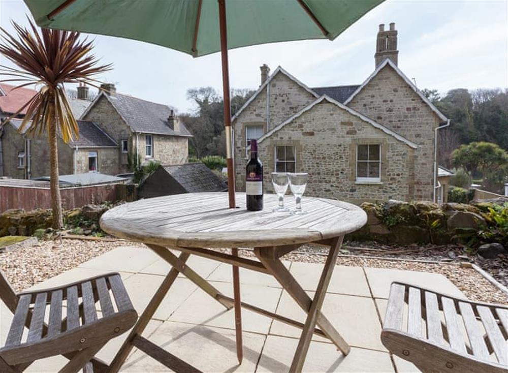 Paved patio area with outdoor furniture at Melville Lodge in Ventnor, Isle of Wight