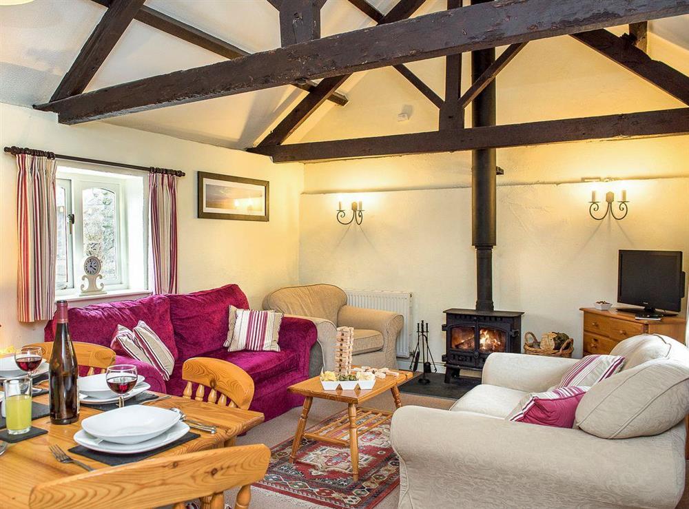 Characterful exposed beams in living and dining room at The Shippon, 