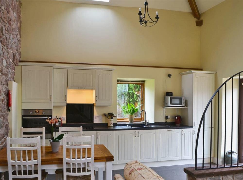 Galley-style kitchen area  with electric oven, ceramic hob, microwave, fridge/freezer and dishwasher. at Mere Croft in Sowerby Row near Penrith, Cumbria
