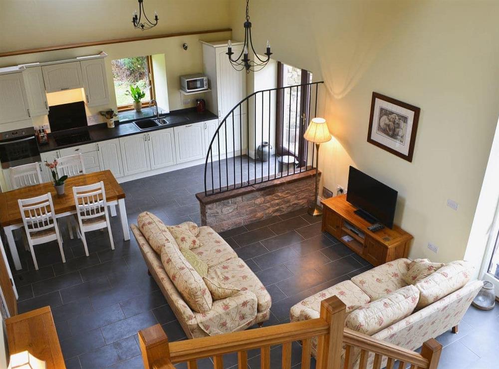 Open plan living space with beams and tiled floor. at Mere Croft in Sowerby Row near Penrith, Cumbria