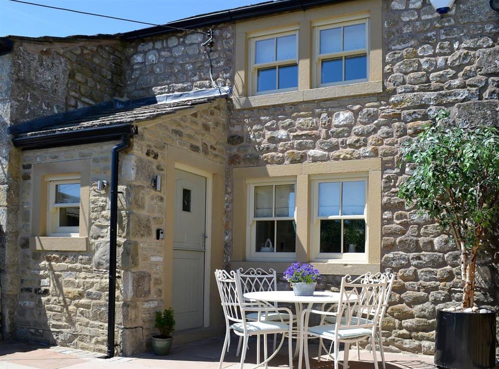 Charming stone built holiday property with seating area and patio at Adair Cottage, 