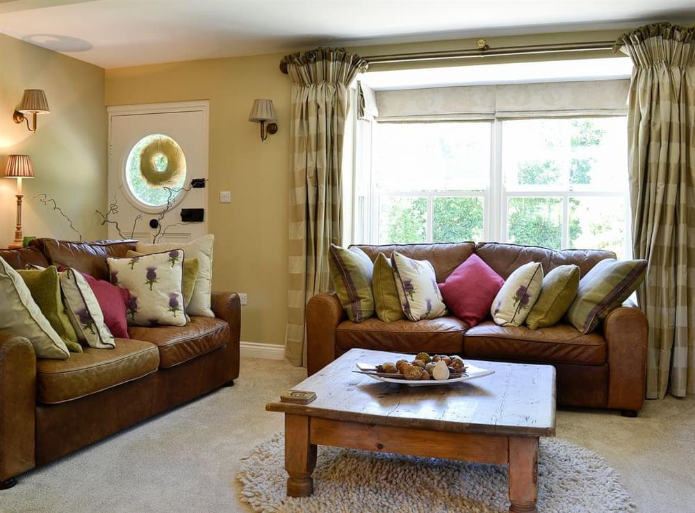 Comfortable and warm living room with wood burner at Graydon Cottage, 