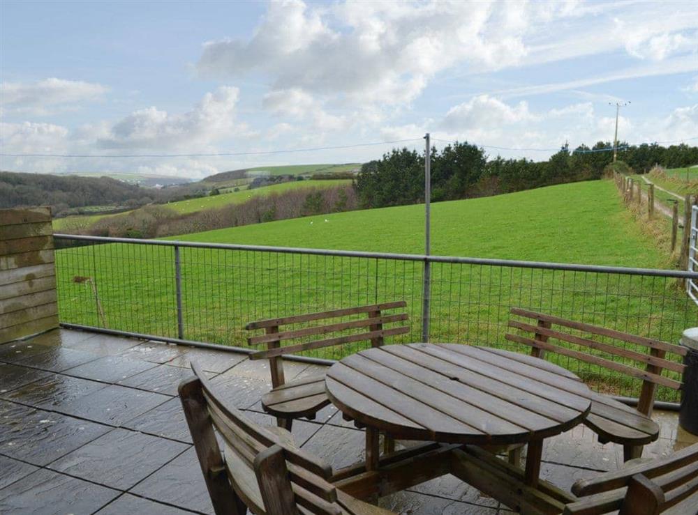 Paved patio area with seating at Merlin View in St Mawgan, near Newquay, Cornwall