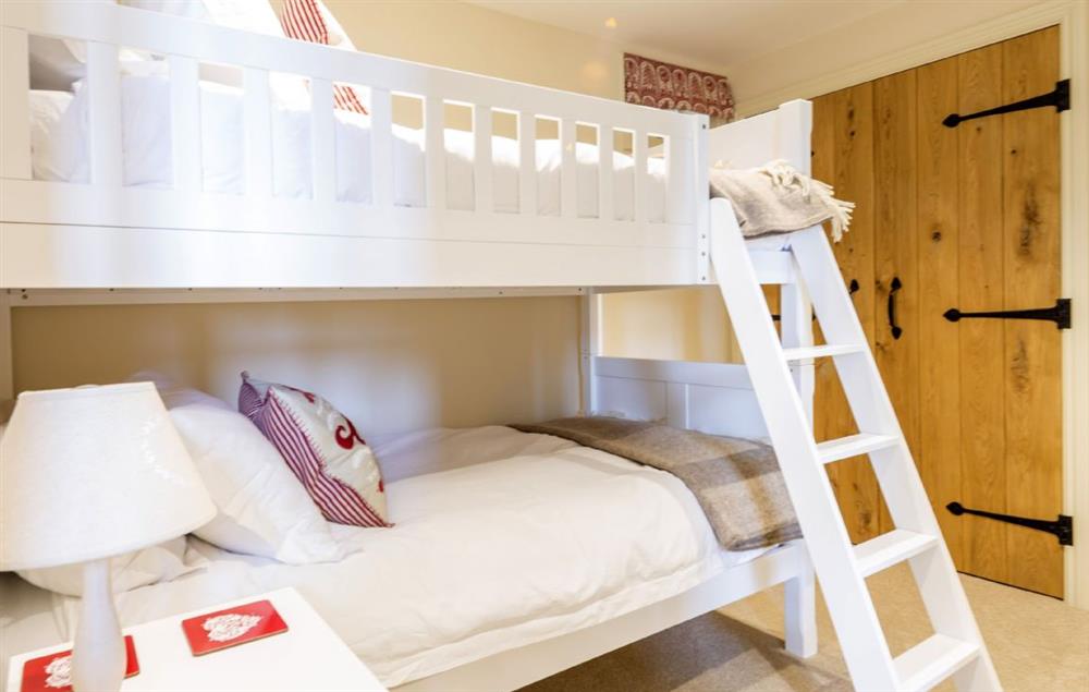 Bedroom three with bunk beds suitable for children and en-suite shower room at Merry Hill Barn, Portesham