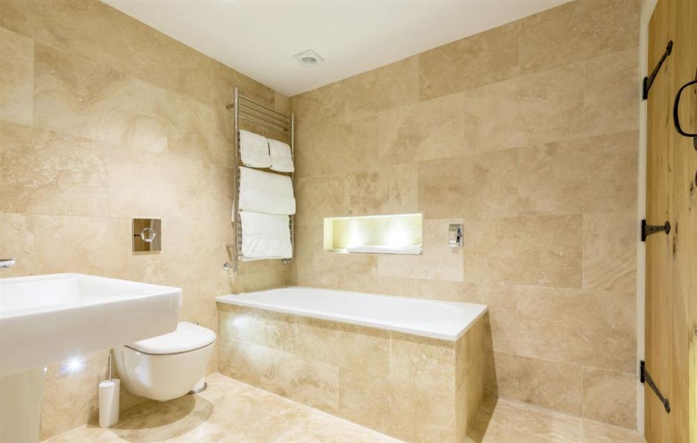 En-suite bathroom with bath and separate shower at Merry Hill Barn, Portesham