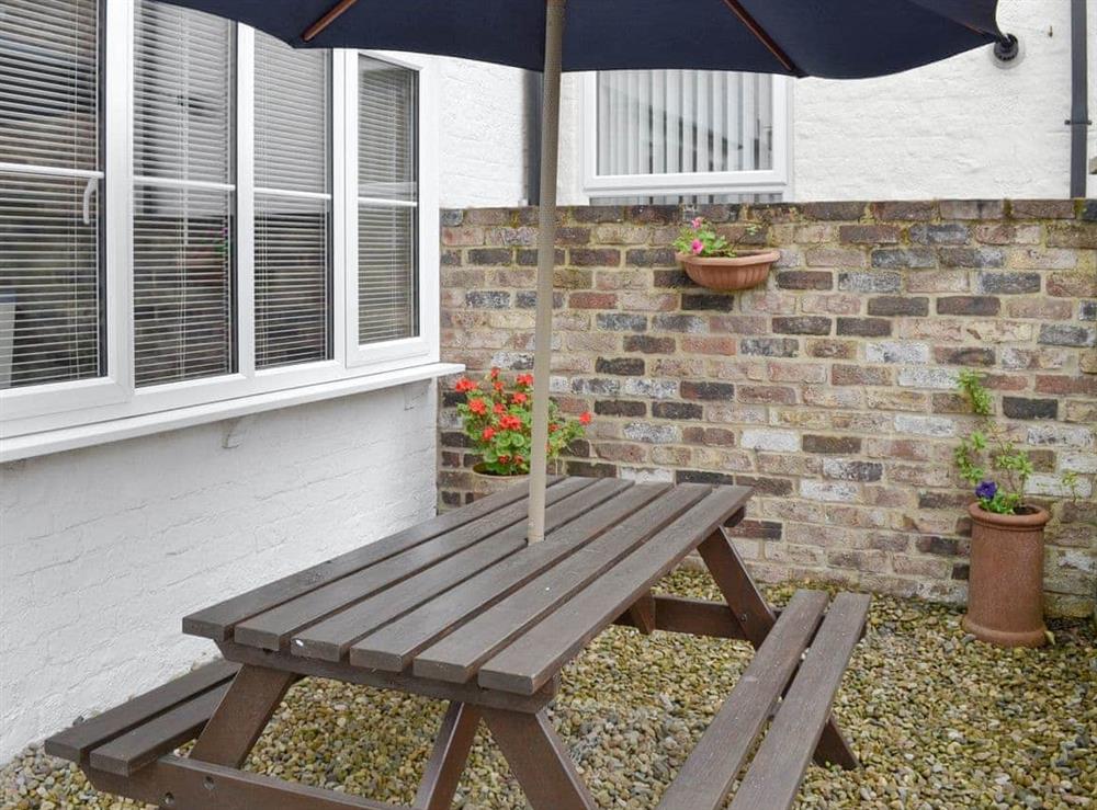 Patio area with outdoor furniture at Mews Cottage in Bridlington, Yorkshire