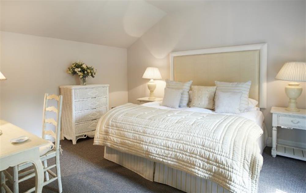 Double bedroom with zip and link beds and en-suite shower room at Mews Cottage, Helston