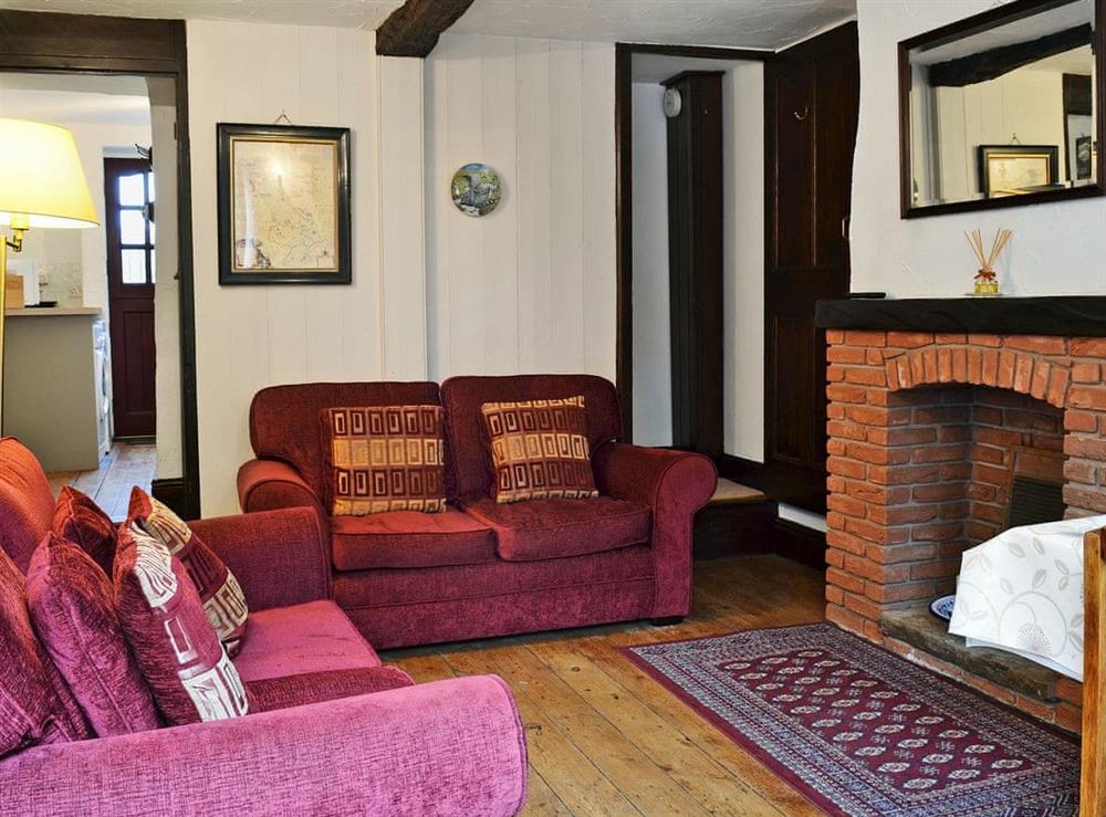 Warm and welcoming living room with beams (photo 2) at Michill Cottage in Castleton, near Hope, Derbyshire, England
