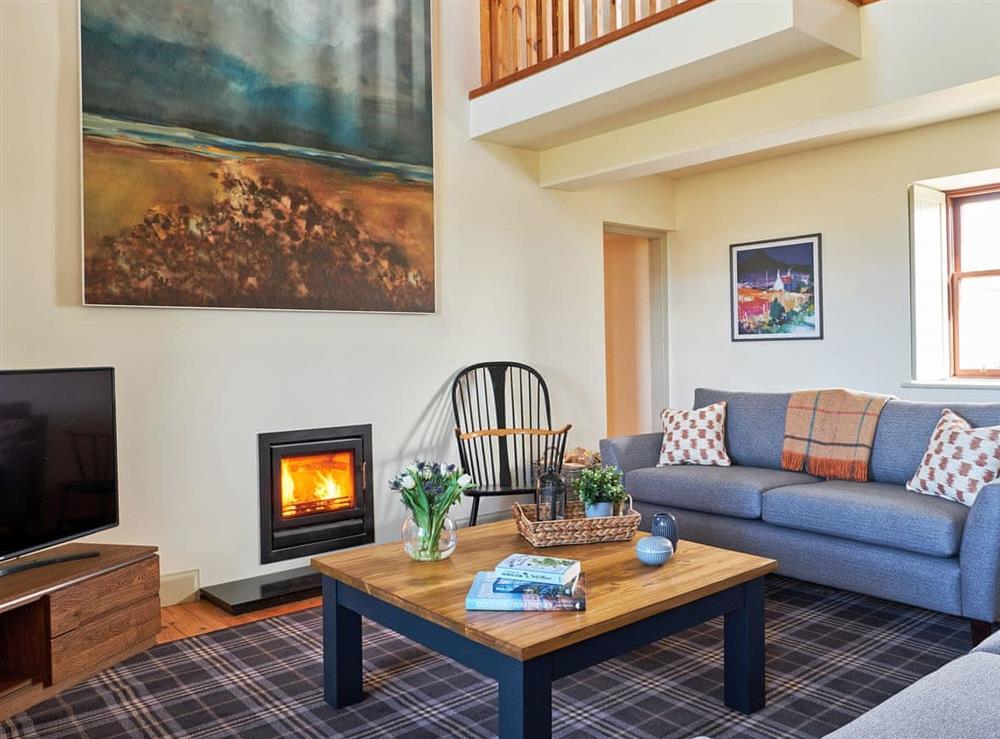 Spacious living room with wood burner at Midcraigs in Glencraigs, near Campbeltown, Argyll