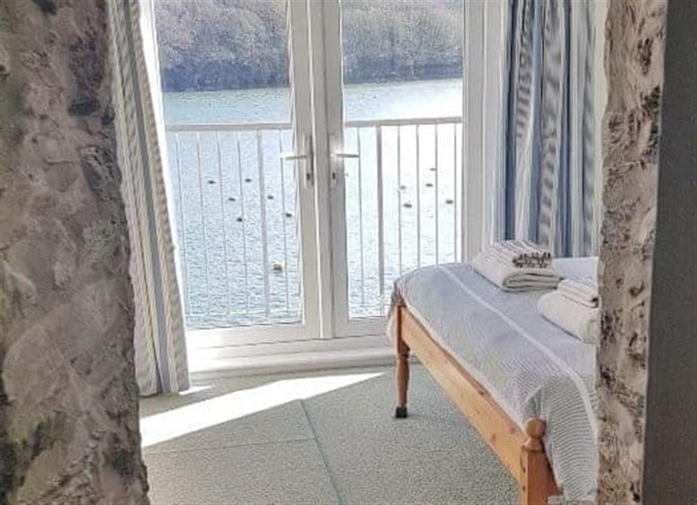 Double bedroom with double doors leading out onto the balcony with lovely river views (photo 2) at Middle Deck in Fowey, Cornwall