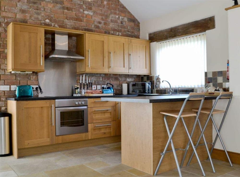 Well equipped kitchen with breakfast bar at Blackberry Barn, 