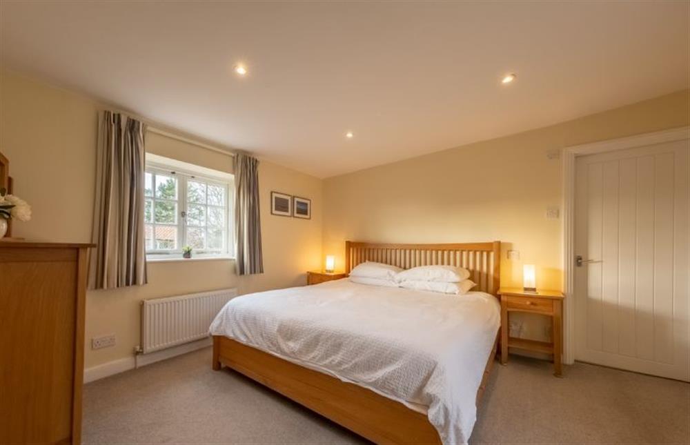 Middle Knoll: Master bedroom with a  super-king size bed at Middle Knoll, Cley-next-the-Sea near Holt