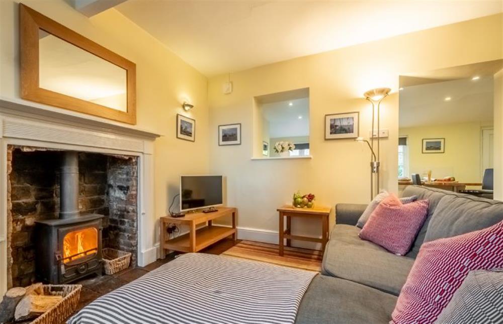 Middle Knoll: Sitting room with log burner and plenty of seating  at Middle Knoll, Cley-next-the-Sea near Holt