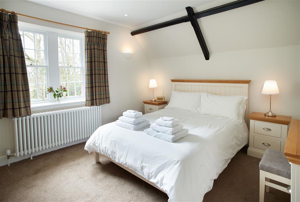 Bedroom with a 5’ king-size bed at Middle Lodge, Netherby Hall, Longtown