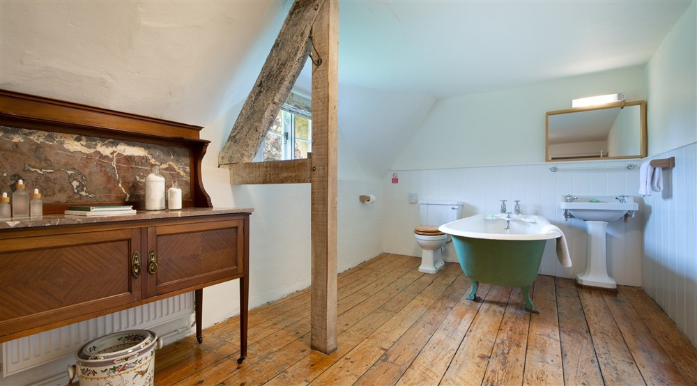 The bathroom, with freestanding bath, on the first floor of Middlebere Farmhouse, Dorset at Middlebere Farmhouse in Isle Of Purbeck, Dorset