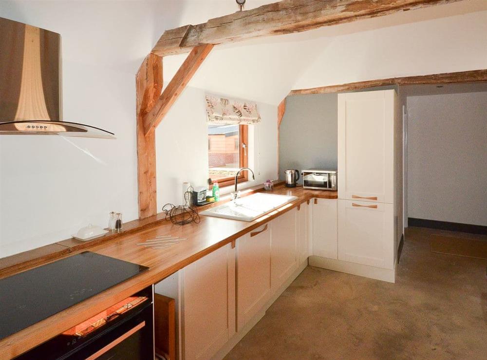Contemporary kitchen area complements the living area beautifully at Chiddock Cottage, 