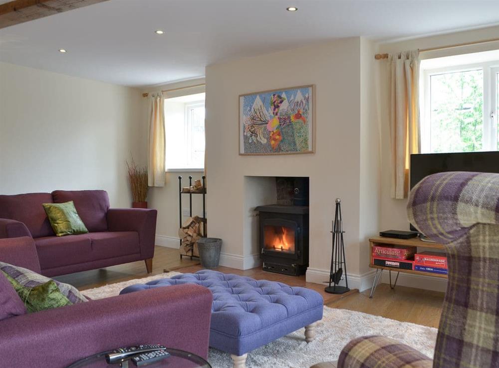 Cosy living room with wood burner at Midland Barn in Renwick, near Penrith, Cumbria