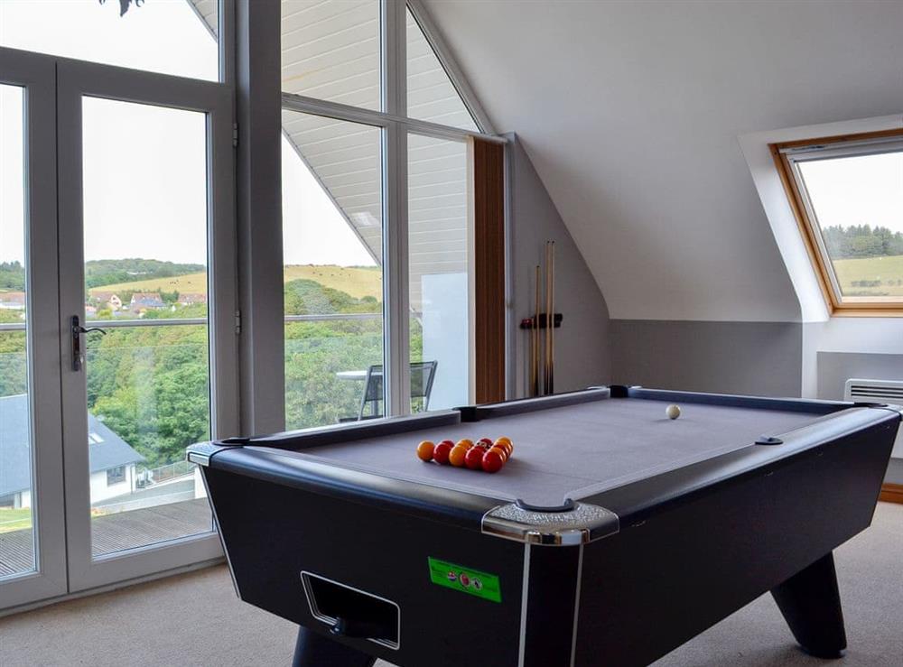 Pool table and large windows/ doors leading onto balcony at No 7 Military Drive, 