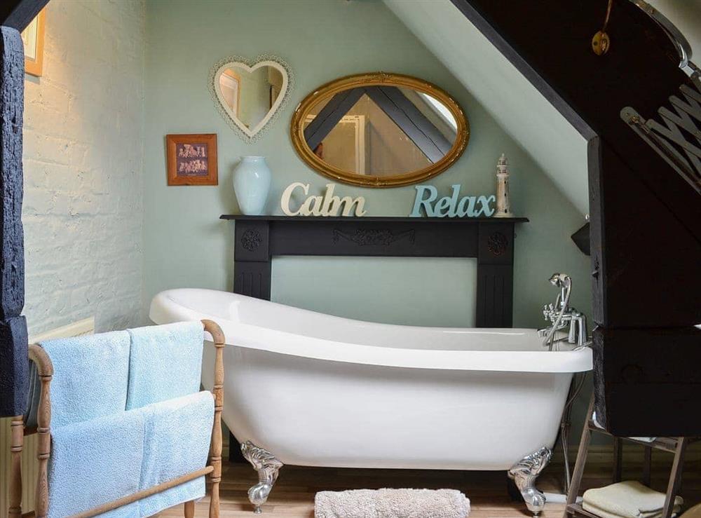 Quirky bathroom with roll-top bath at Mill Cottage in Bielby, near York, North Yorkshire