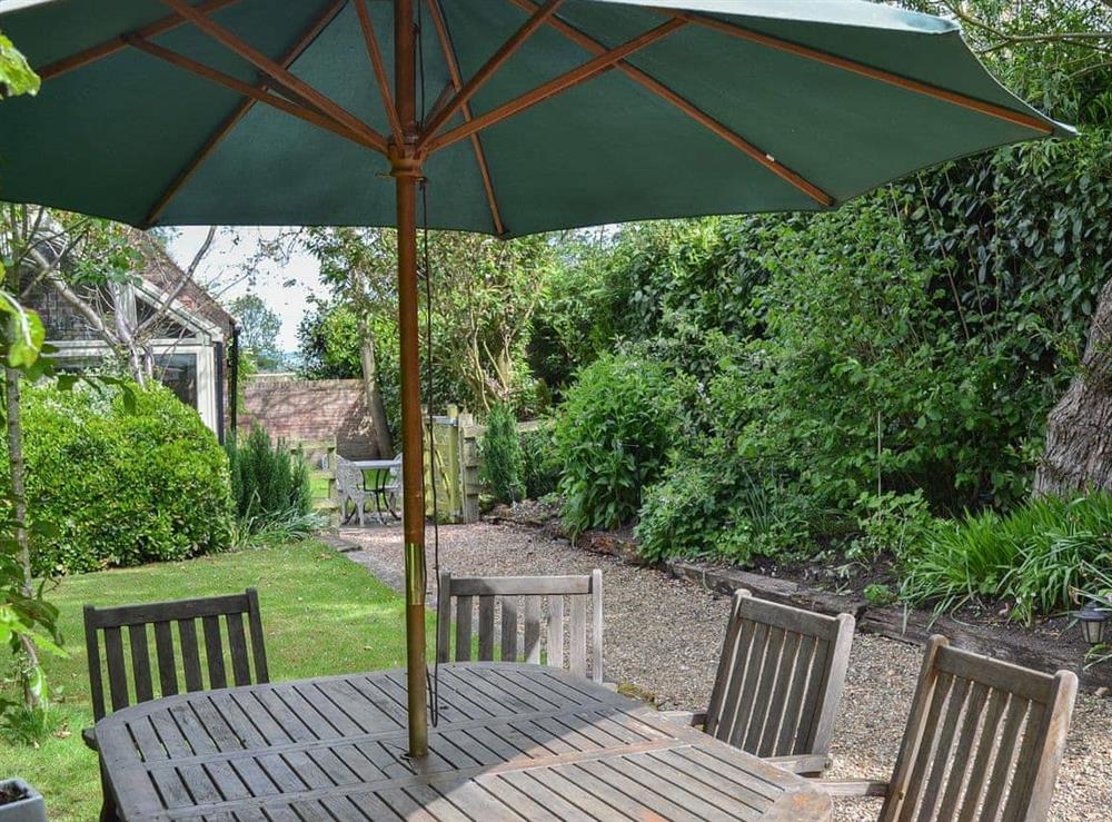 Shady table and chairs in the garden for alfresco entertaining at Mill Cottage in Bielby, near York, North Yorkshire