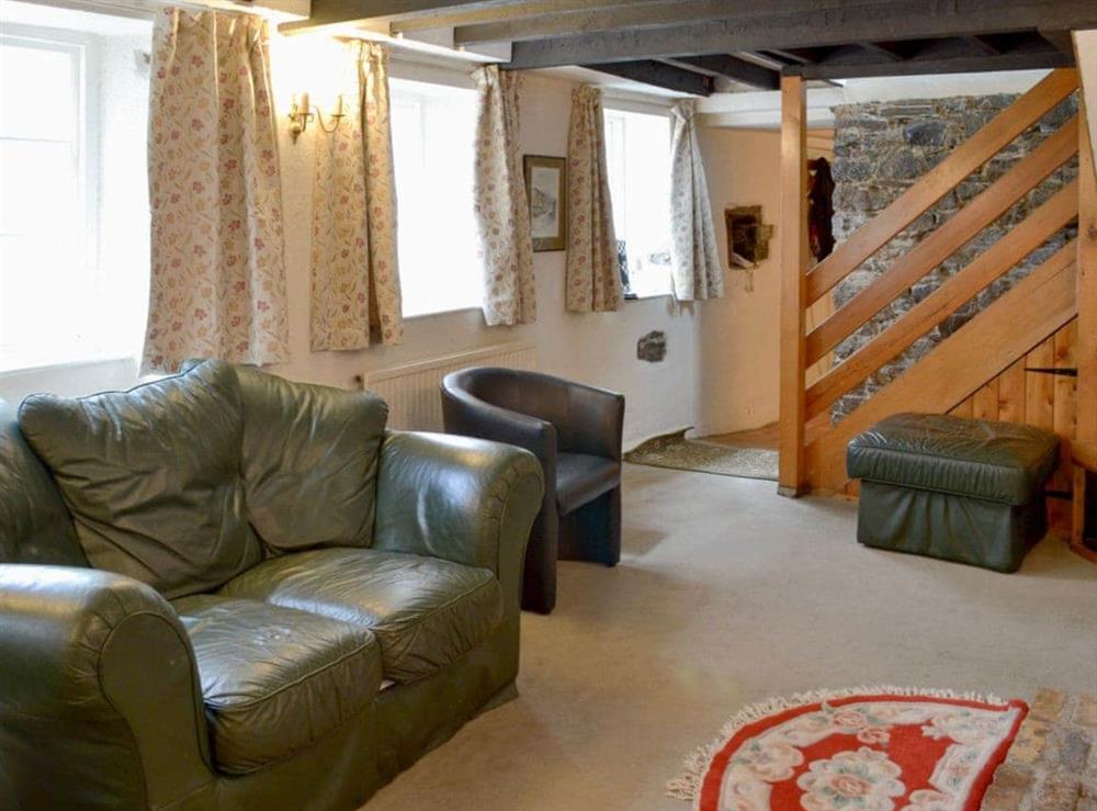 Living room with beamed ceiling at Mill Cottage in Buckfastleigh, near Dartmoor, Devon