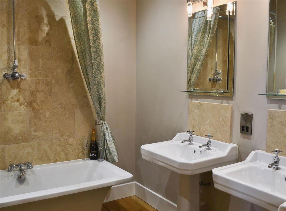 En-suite with shower over bath and WC at Mill Cottage in Dalton near Richmond, North Yorkshire