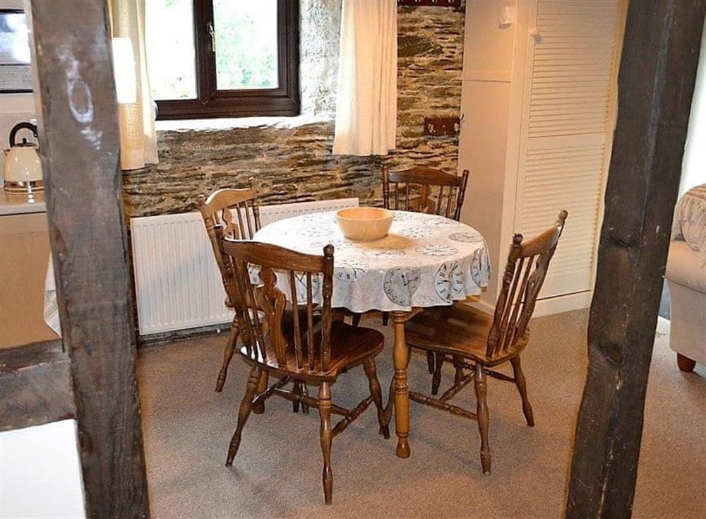 Dining area with seating for four people at Mill Cottage in Fowey, Cornwall