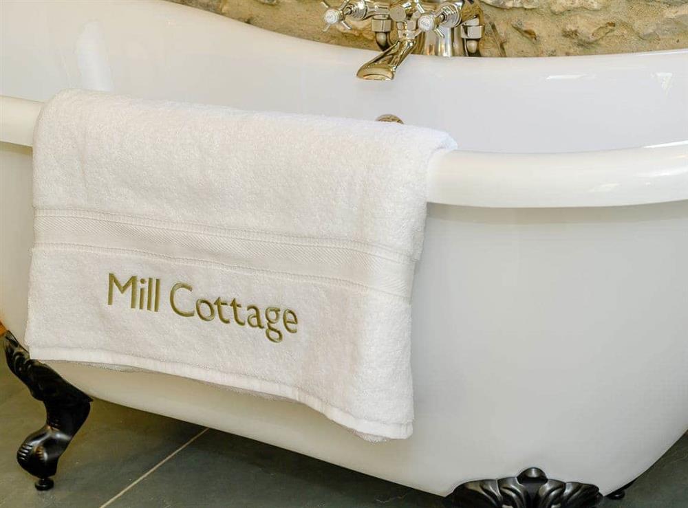Roll-top bath within the double bedroom at Mill Cottage in Hawkchurch, near Axminster, Devon