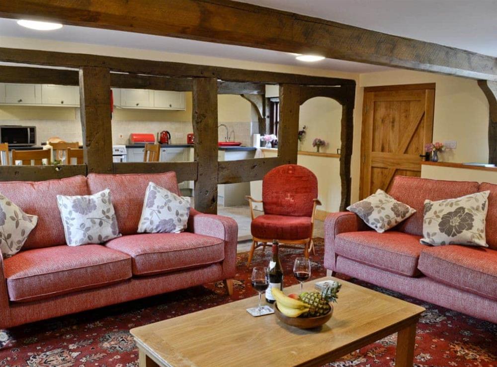 Living room with exposed wood beams at Mill Cottage in Peterchurch, near Hay-on-Wye, Herefordshire