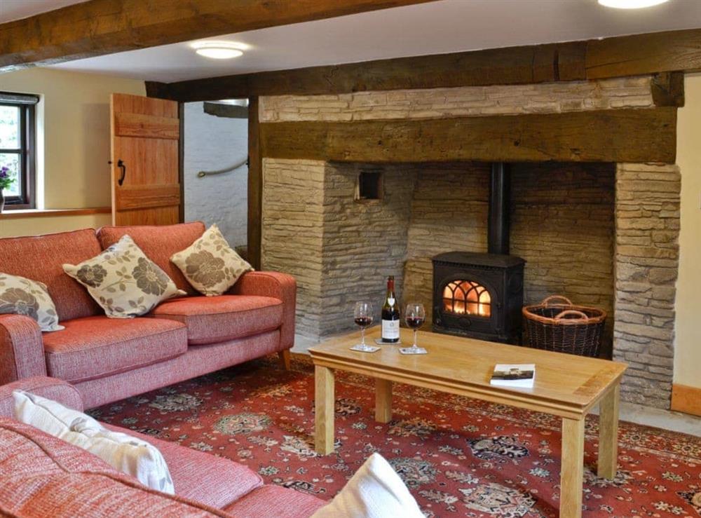 Living room with inglenook fireplace & wood burner at Mill Cottage in Peterchurch, near Hay-on-Wye, Herefordshire