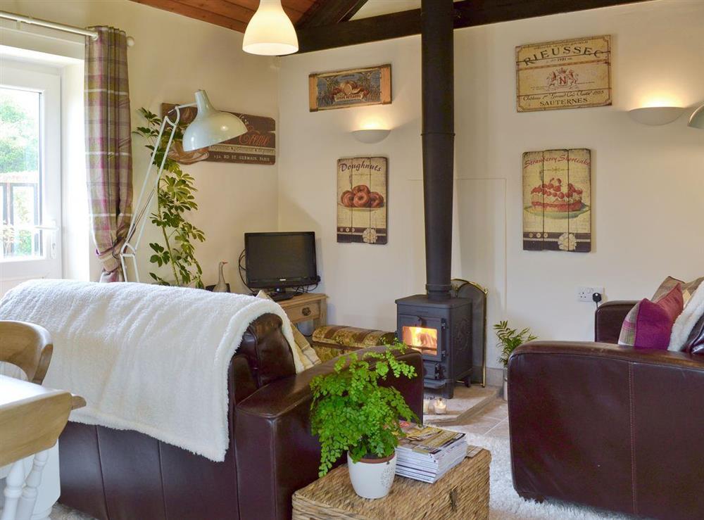 Charming living and dining room with wood burning stove at Mill Cottage in Stillington, near York, North Yorkshire