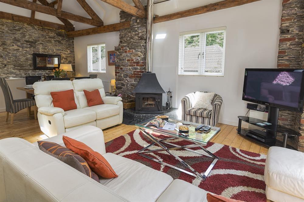 Cosy sitting area with wood-burning stove at Mill Grange in , Dartmouth