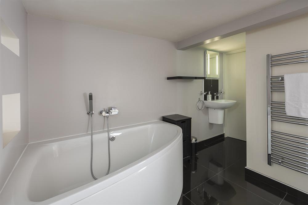 En suite bathroom with corner bath at Mill Grange in , Dartmouth