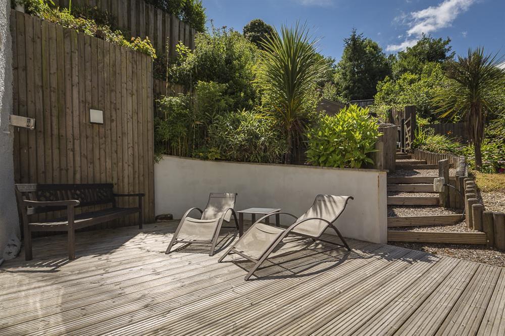 French doors lead to a private decking area with loungers and seating at Mill Grange in , Dartmouth