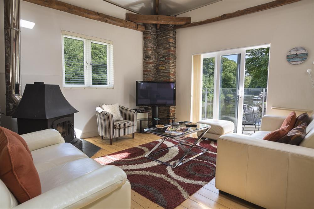 Living area with doors leading out to the terrace at Mill Grange in , Dartmouth