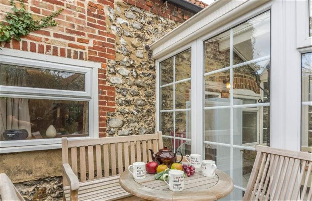 Enjoy a coffee in the courtyard outside at Mill House Cottage, Brancaster near Kings Lynn