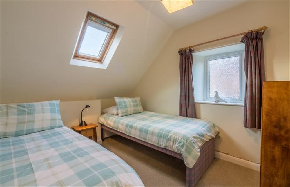 First floor: Bedroom two has a single bed and trundle bed at Mill House Cottage, Brancaster near Kings Lynn