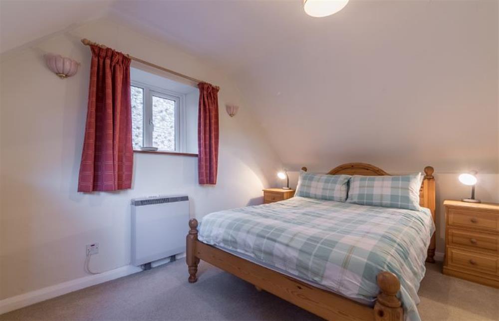 First floor: The Master bedroom has comfortable double bed at Mill House Cottage, Brancaster near Kings Lynn