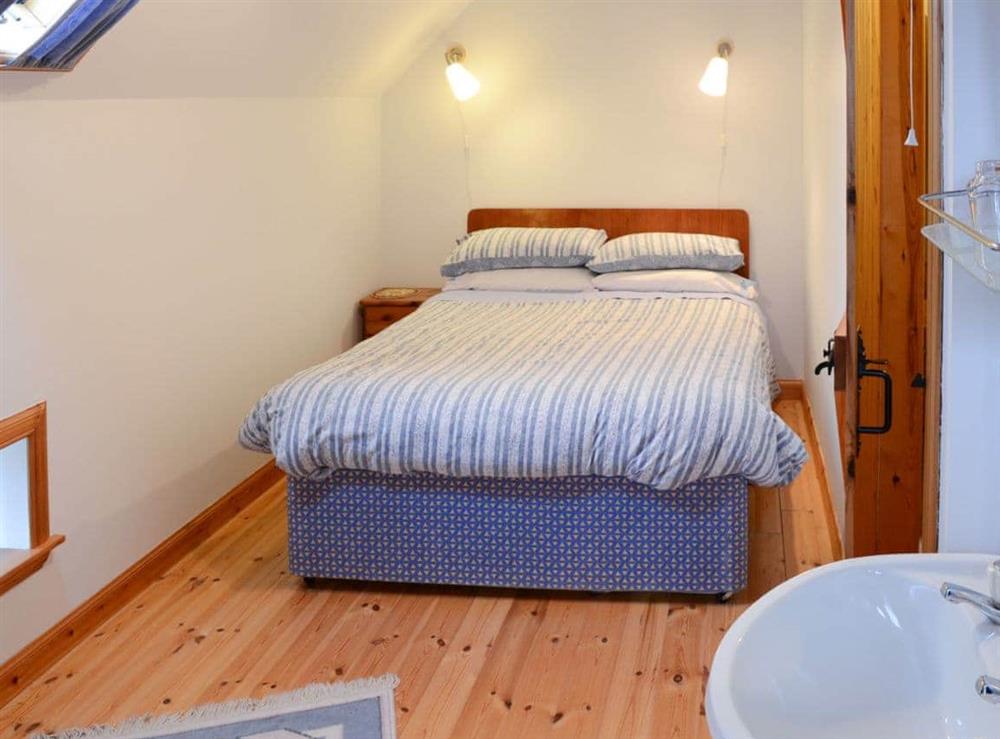 Inviting double bedroom with sloping ceiling at Mill Cottage, 