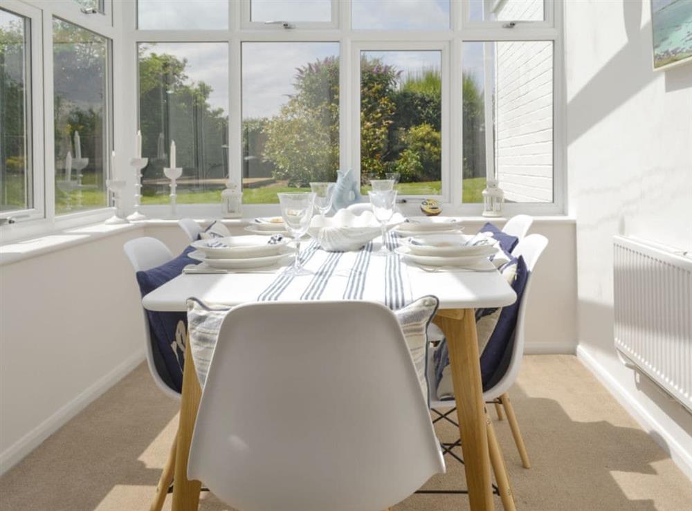 Light and airy dining area within conservatory at Mill House in Docking, near Hunstanton, Norfolk
