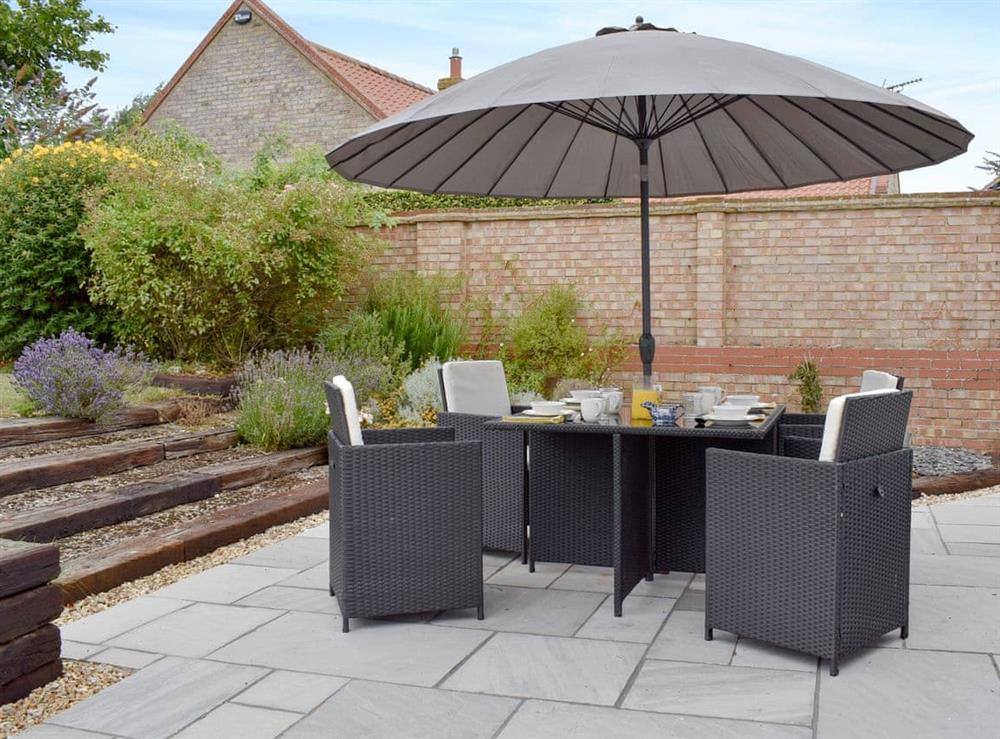 Paved patio with outdoor furniture at Mill House in Docking, near Hunstanton, Norfolk