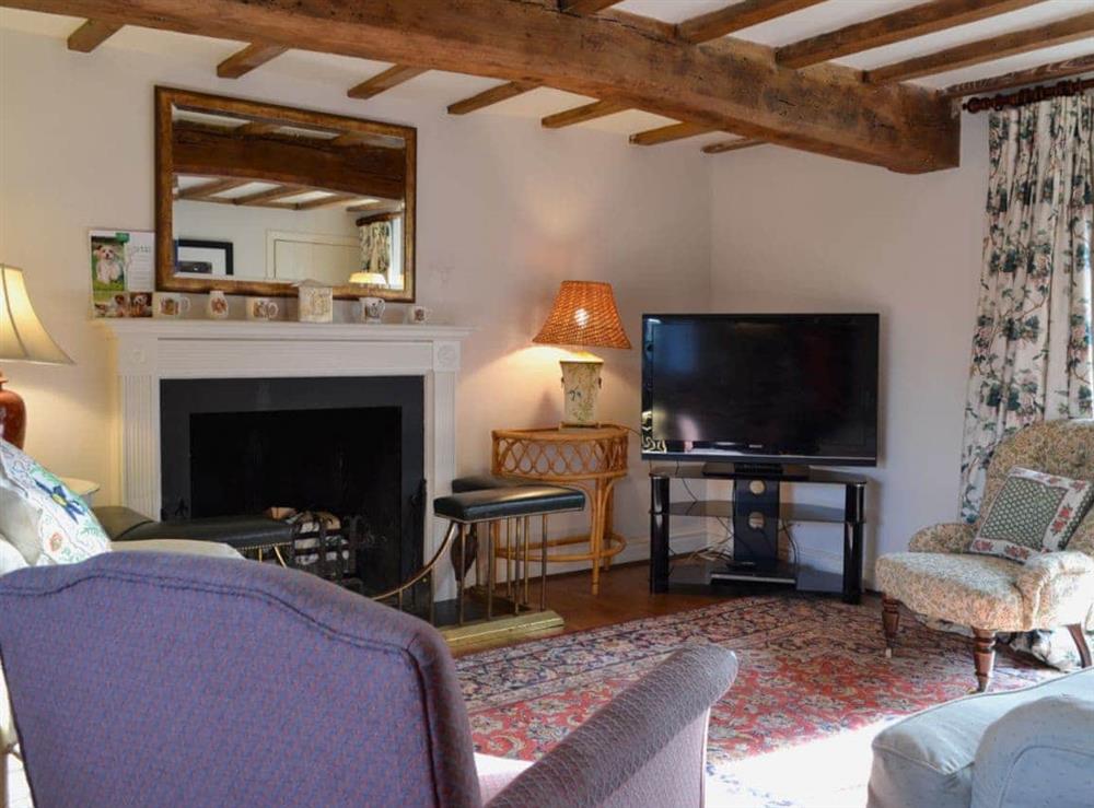 Cosy living room with open fire at Mill House in Rievaulx, near Helmsley, North Yorkshire