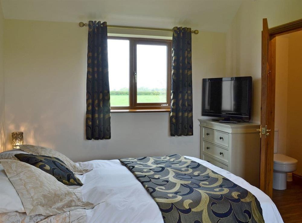 Elegant double bedroom with en-suite with shower cubicle (photo 2) at Mill Stone Cottage in Nr. Chapel St Leonards, Lincolnshire