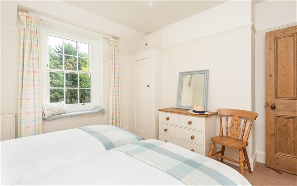 Bedroom 2-with twin beds and garden views at Millbay Cottage in East Portlemouth