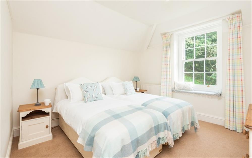 Bedroom 2 with views over the garden and woodland beyond at Millbay Cottage in East Portlemouth