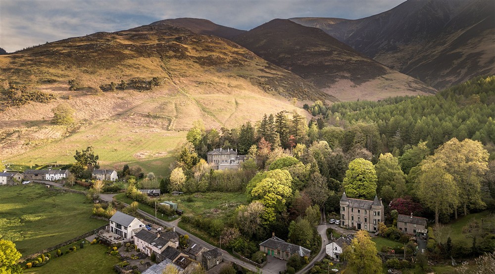 An aerial view of Millbeck village and Millbeck Towers, with Skiddaw to the right, Cumbria at Millbeck Towers in Keswick, Cumbria