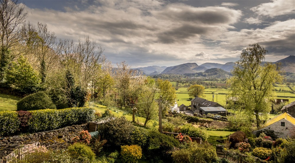 An aerial view of the front garden, looking towards the fells around Derwentwater, including Catbells, Cumbria at Millbeck Towers in Keswick, Cumbria