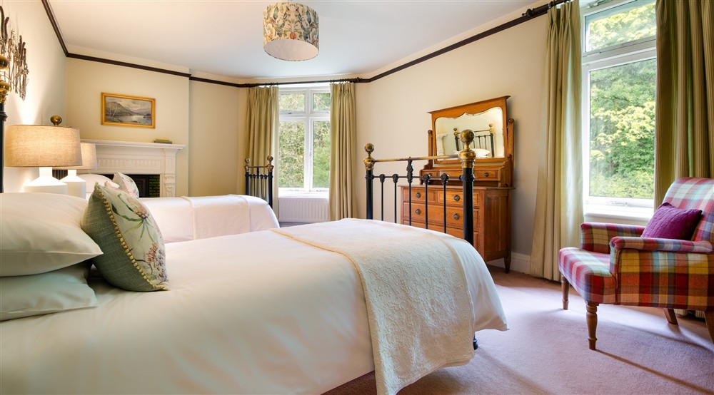 The second floor twin bedroom, which overlooks the large rear garden at Millbeck Towers in Keswick, Cumbria